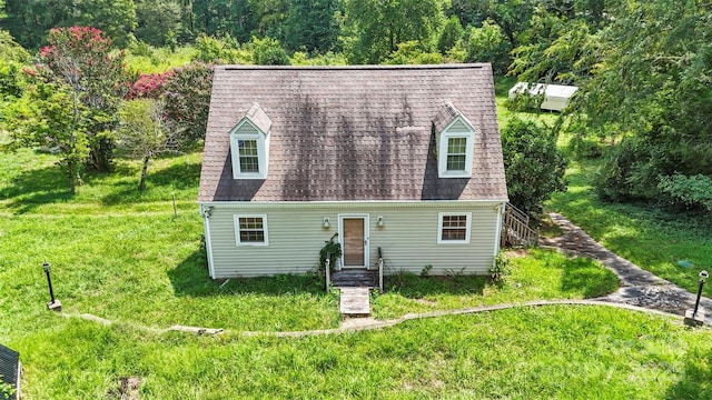 cape cod home with a front yard