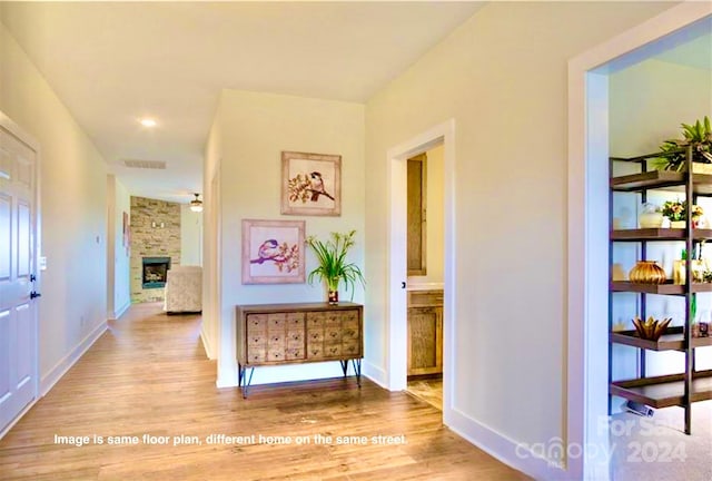 corridor with light hardwood / wood-style flooring