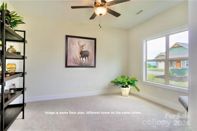 living area featuring ceiling fan and light colored carpet