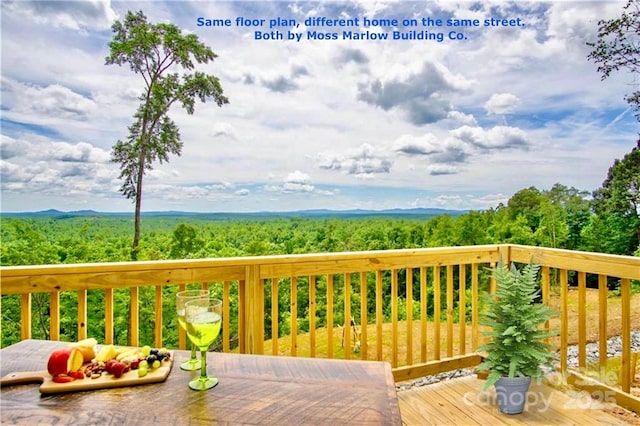 wooden deck featuring a wooded view