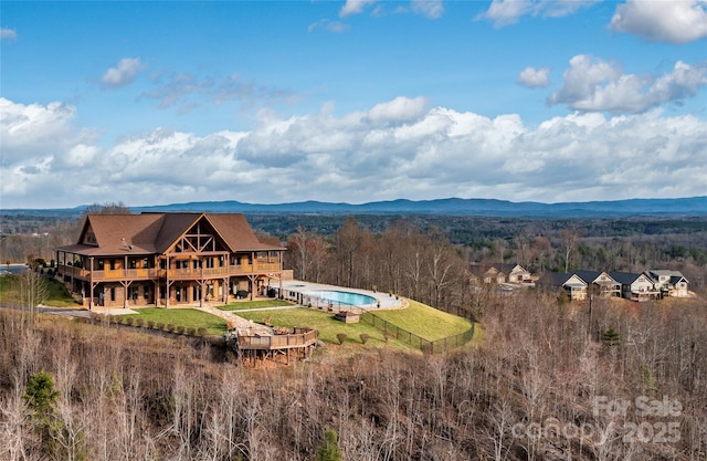 exterior space featuring a mountain view and a wooded view