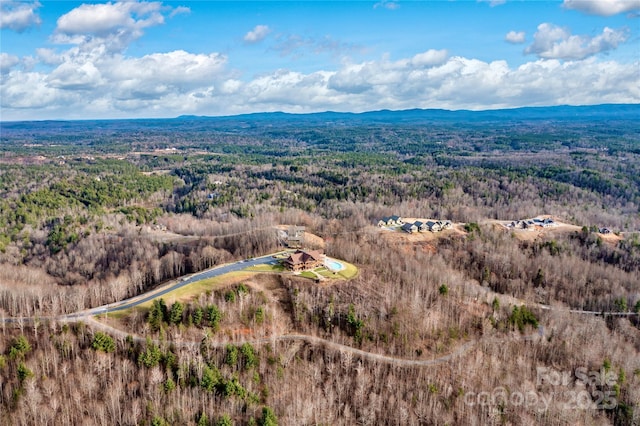 aerial view featuring a mountain view and a forest view