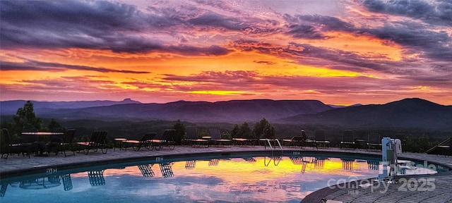 view of swimming pool with a mountain view