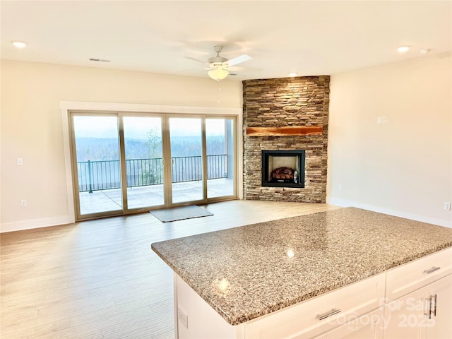 1387 River Club Rdg, Lenoir, NC 28645 - kitchen with white cabinetry, light stone countertops, visible vents, and ceiling fan