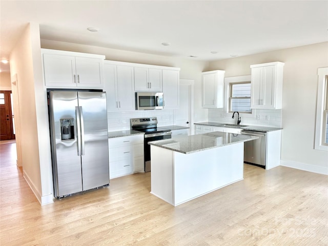 1387 River Club Rdg, Lenoir, NC 28645 - kitchen with light stone counters, stainless steel appliances, light wood-style floors, and a sink