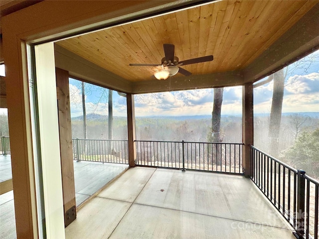 1387 River Club Rdg, Lenoir, NC 28645 - unfurnished sunroom with wooden ceiling, a forest view, and a ceiling fan
