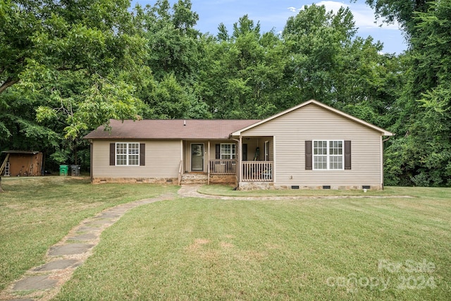 ranch-style house featuring a porch and a front lawn