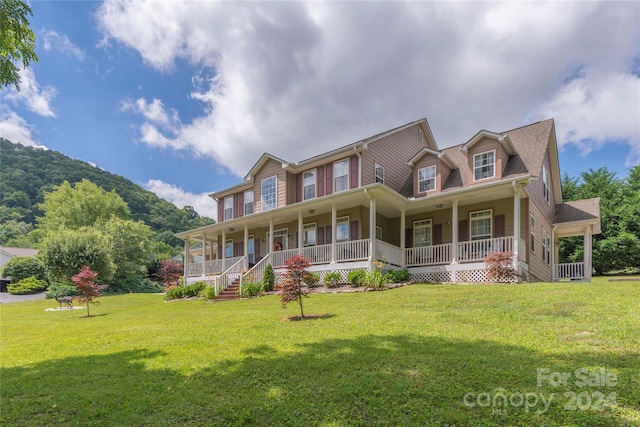 view of front of property featuring covered porch and a front yard