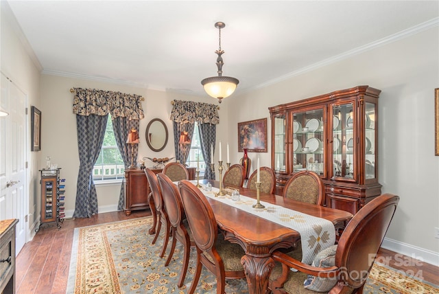 dining space featuring hardwood / wood-style floors and crown molding