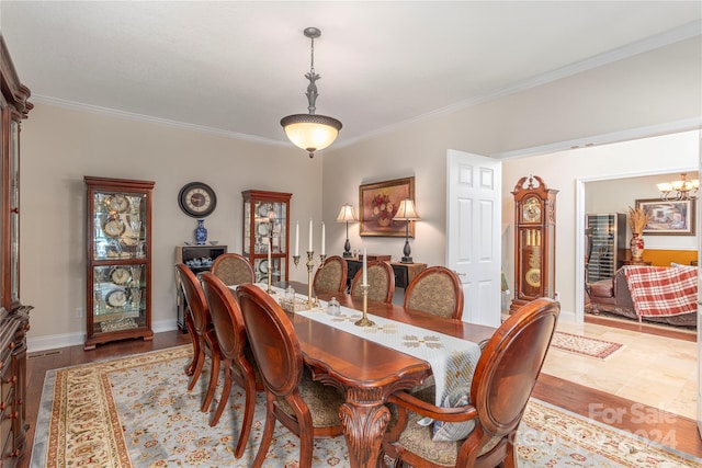 dining room featuring ornamental molding, a chandelier, and hardwood / wood-style flooring