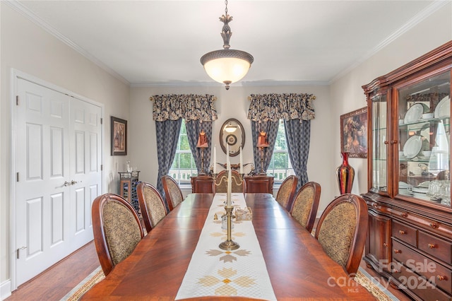 dining area featuring crown molding and dark hardwood / wood-style flooring