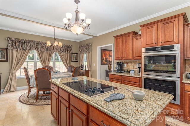 kitchen featuring a chandelier, a center island, decorative light fixtures, black electric stovetop, and stainless steel double oven