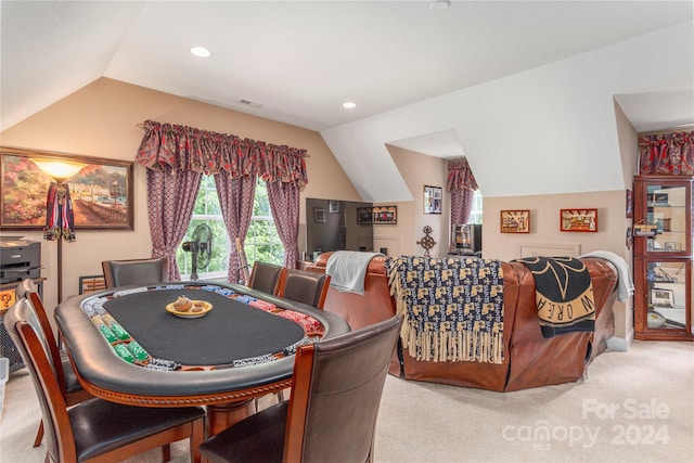 rec room featuring lofted ceiling and light carpet