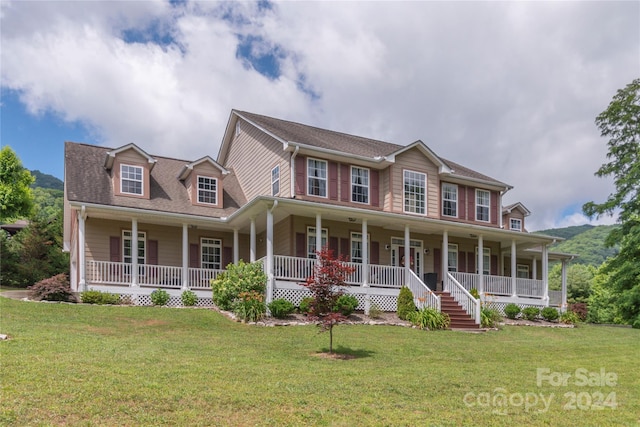 colonial home featuring covered porch and a front lawn