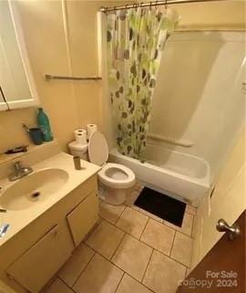 full bathroom with vanity, toilet, shower / bathtub combination with curtain, and tile patterned floors