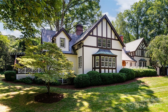 back of house with a lawn