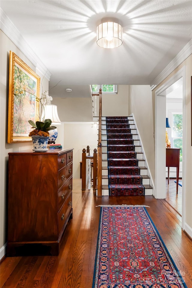 stairway featuring hardwood / wood-style flooring and crown molding