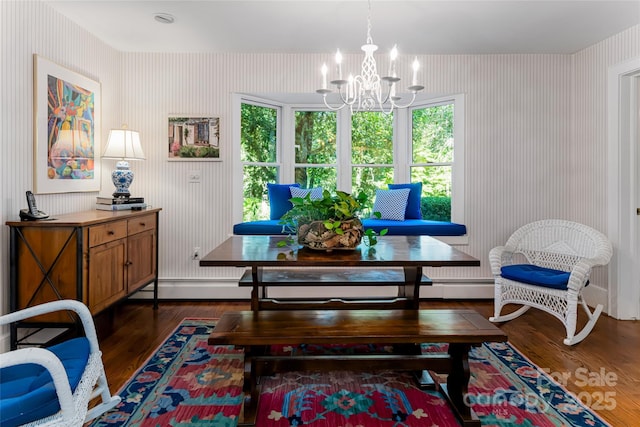 sitting room with a notable chandelier and dark hardwood / wood-style floors