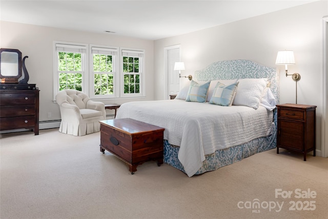 bedroom featuring a baseboard heating unit and light carpet