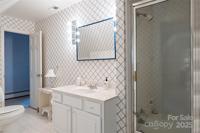 bathroom with vanity, a shower with shower door, toilet, and baseboard heating