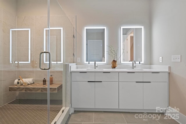 bathroom featuring tile patterned flooring, vanity, and a shower with shower door