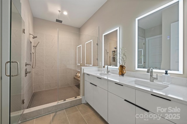 bathroom featuring tile patterned flooring, vanity, and an enclosed shower