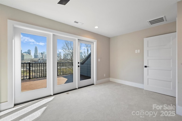 doorway to outside featuring light colored carpet