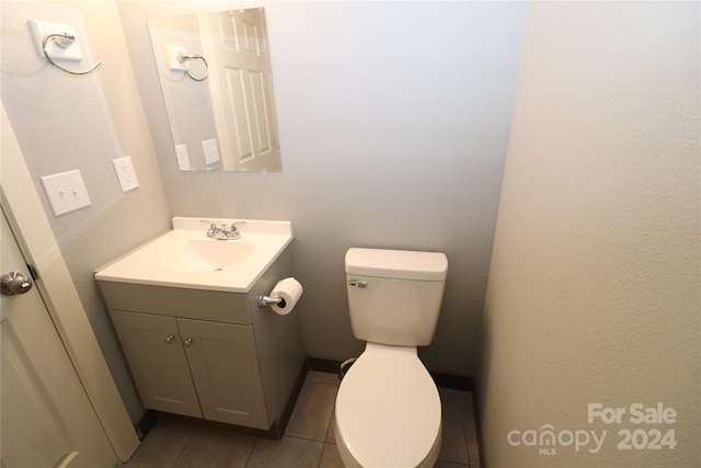 bathroom with tile patterned flooring, toilet, and vanity