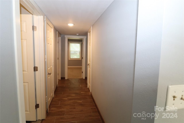 hallway with dark hardwood / wood-style flooring