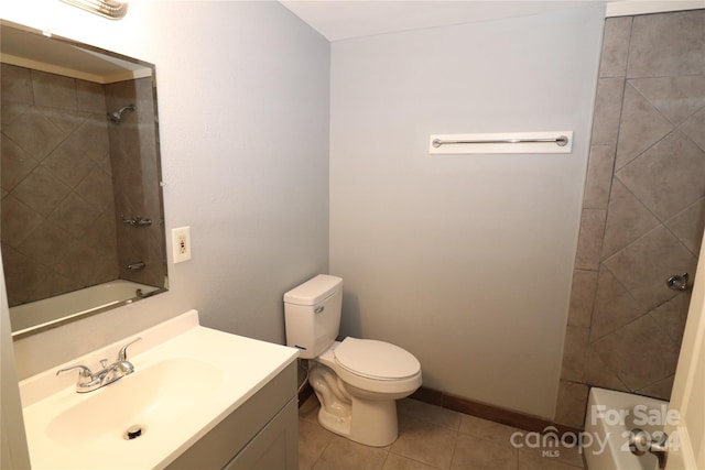 full bathroom featuring tile patterned flooring, vanity, toilet, and tiled shower / bath