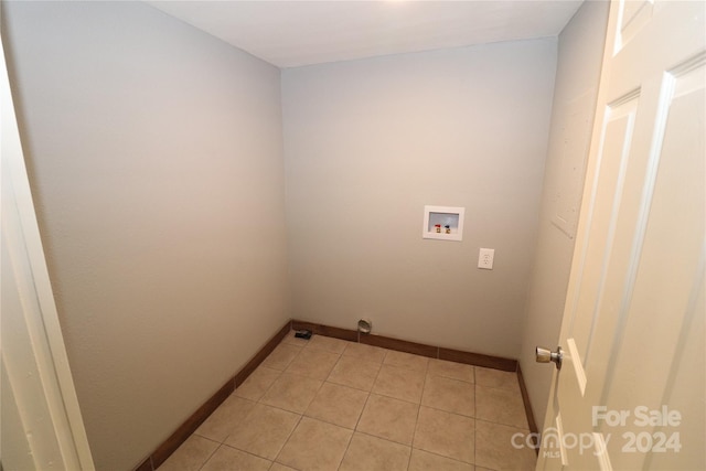 laundry room featuring light tile patterned floors and washer hookup