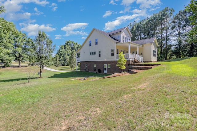 view of property exterior with a yard and covered porch