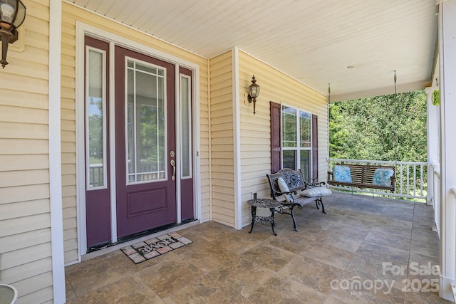 doorway to property featuring a porch