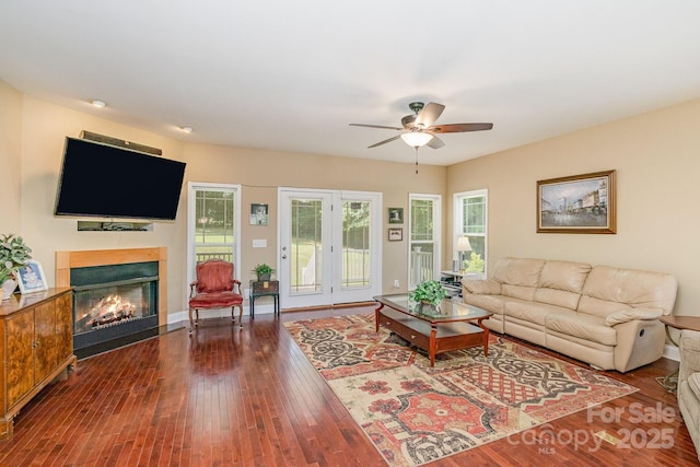 living room with hardwood / wood-style floors and ceiling fan