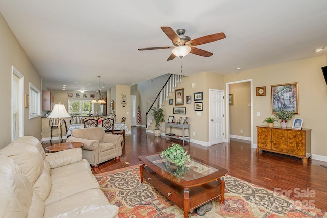 living room with dark hardwood / wood-style floors and ceiling fan