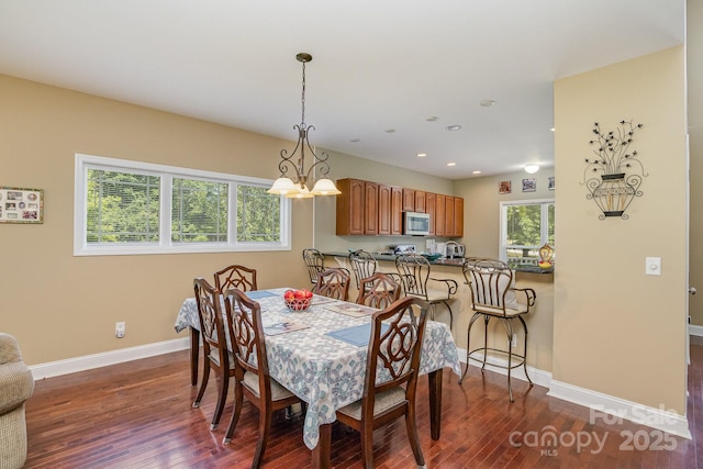 dining space featuring an inviting chandelier and dark hardwood / wood-style floors