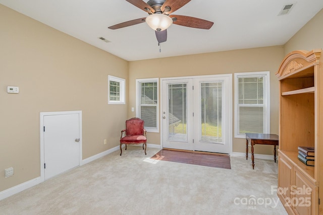 sitting room featuring light colored carpet and ceiling fan