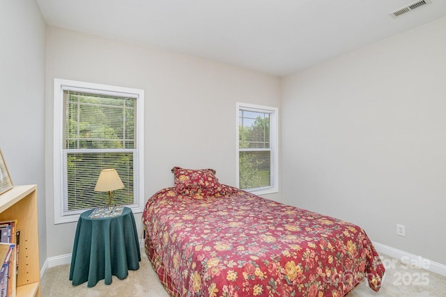 bedroom with light colored carpet