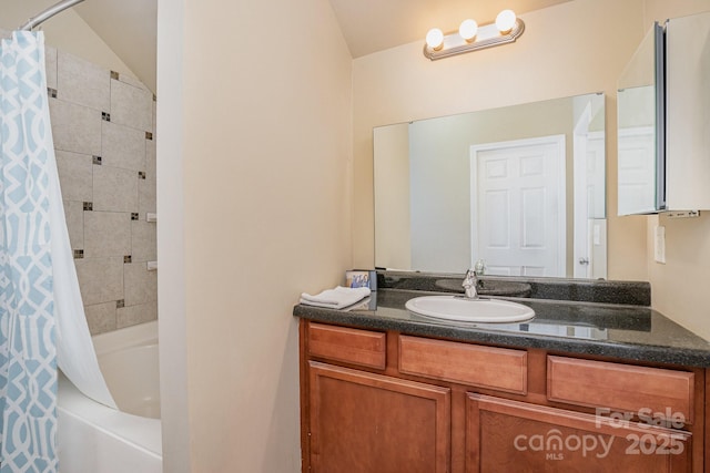 bathroom featuring shower / tub combo with curtain, vanity, and vaulted ceiling