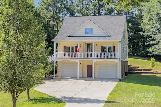 view of front of property with a garage, a front lawn, and covered porch