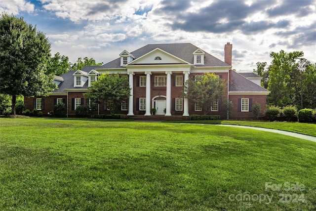 greek revival inspired property with a front yard