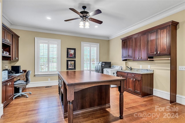 office with light wood-type flooring, ceiling fan, ornamental molding, and washing machine and clothes dryer