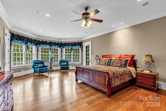 bedroom with ceiling fan, light wood-type flooring, and crown molding