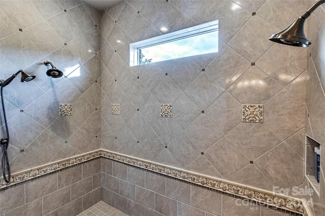 bathroom with a tile shower