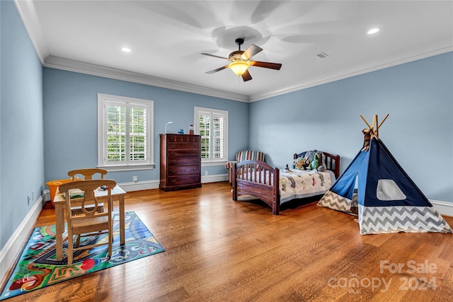 bedroom with ceiling fan, ornamental molding, and hardwood / wood-style floors