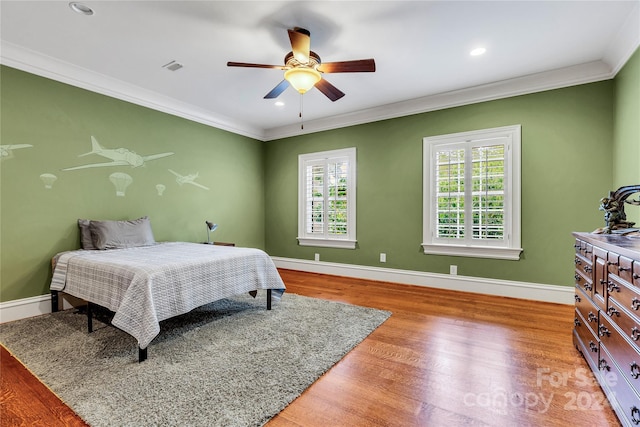 bedroom featuring ceiling fan, ornamental molding, and hardwood / wood-style floors