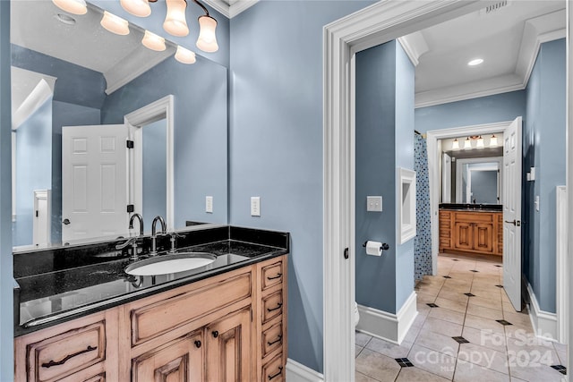 bathroom featuring crown molding, tile patterned floors, and vanity