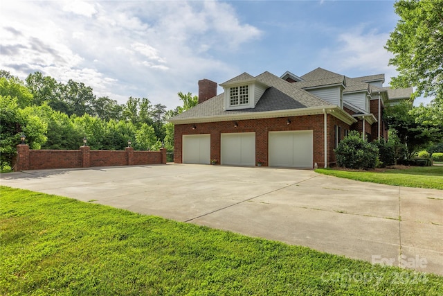 view of side of property with a garage and a lawn