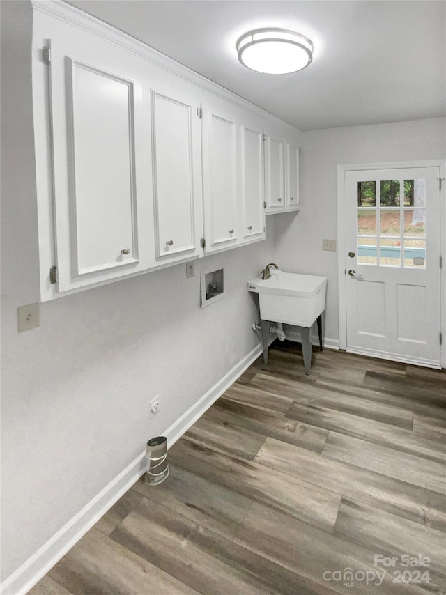 laundry area with sink, dark hardwood / wood-style floors, washer hookup, and cabinets