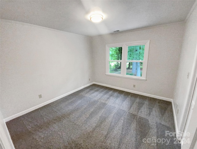 empty room featuring dark colored carpet